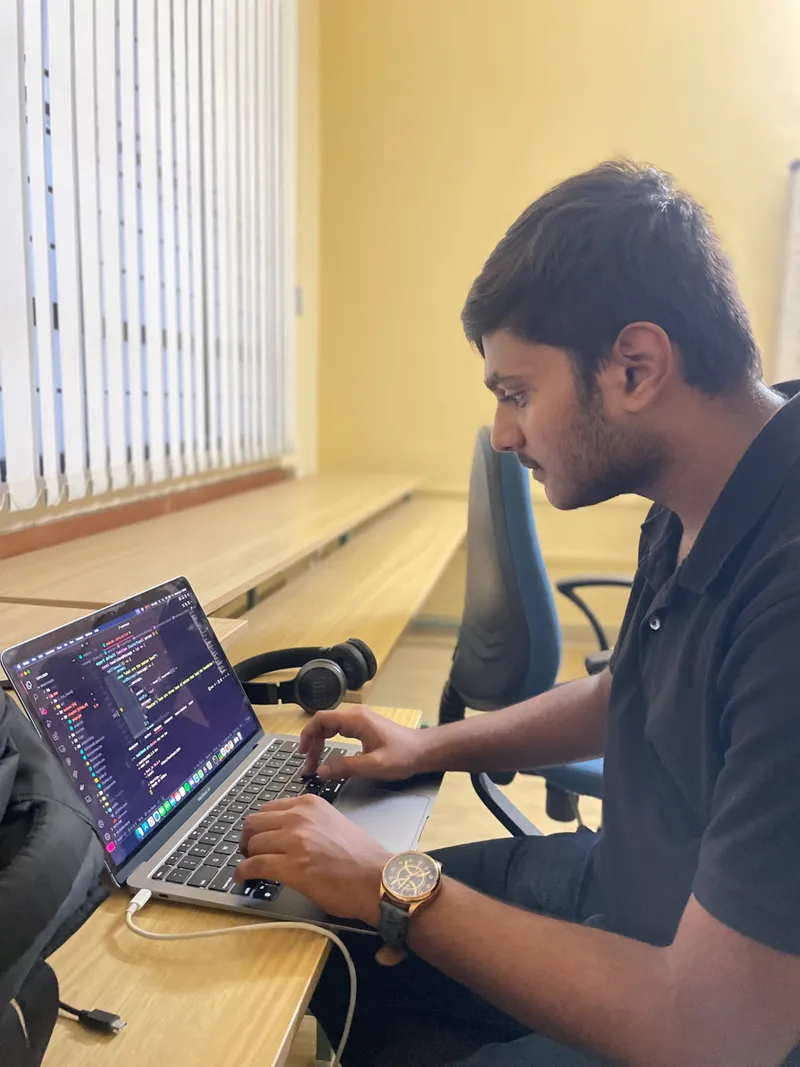 Vachan MN working on his laptop